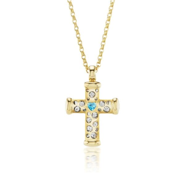 A gold cross with blue and white stones.
