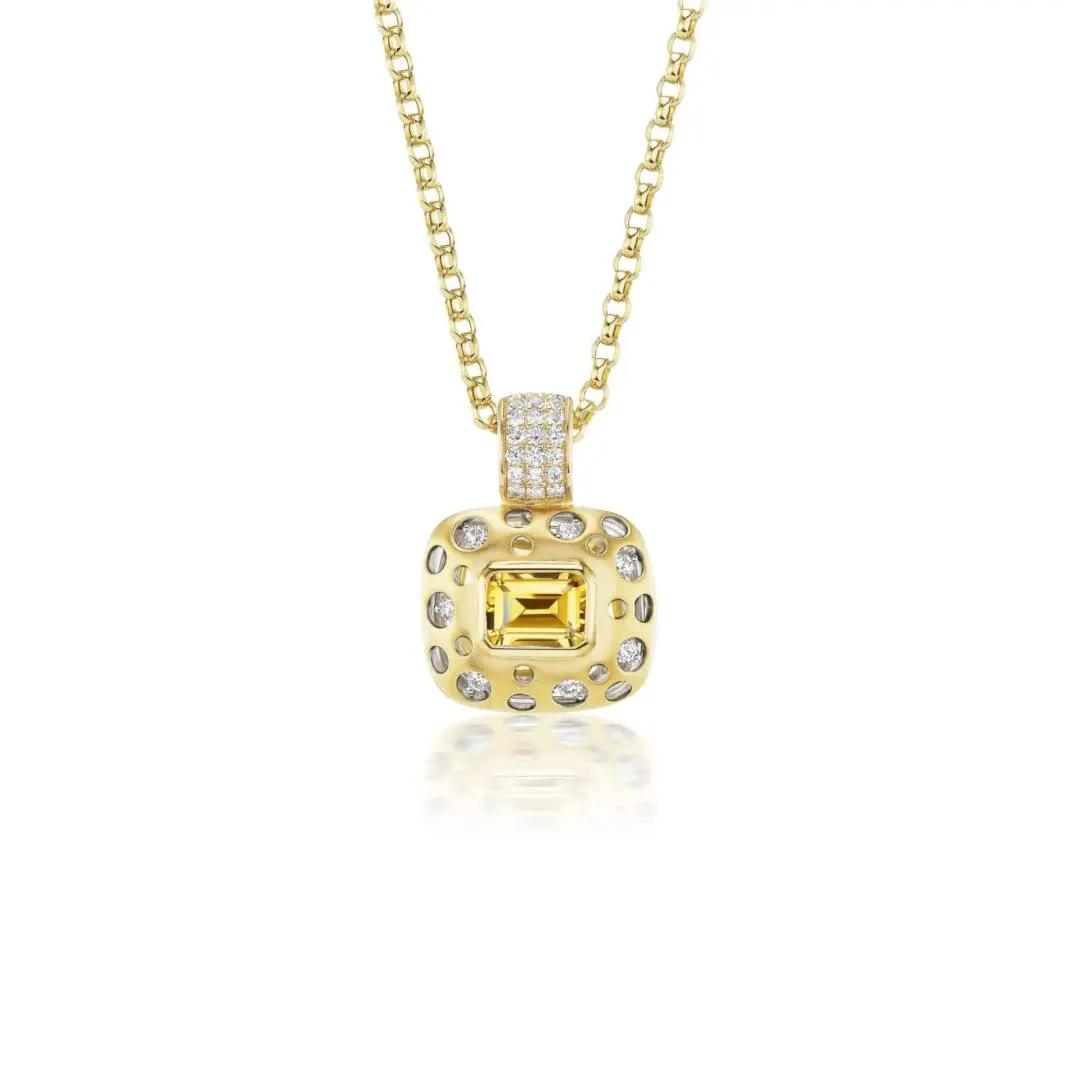 A yellow diamond and white gold pendant necklace.