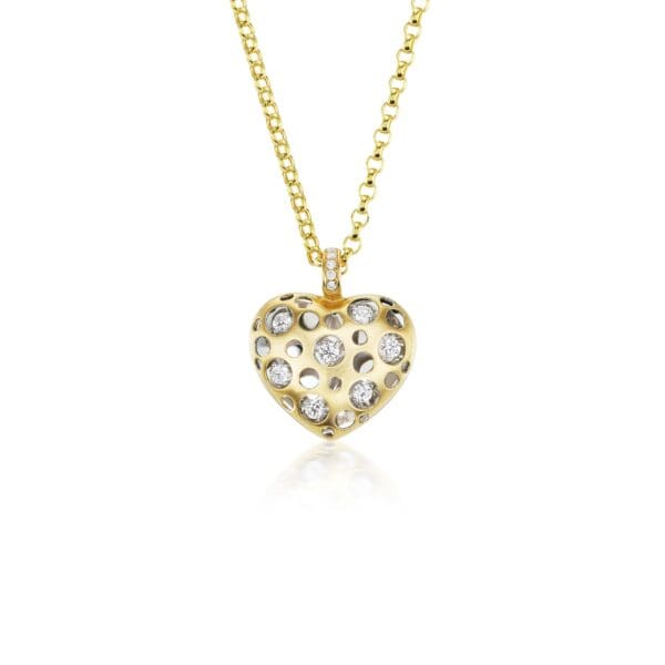 A gold necklace with a heart shaped pendant.