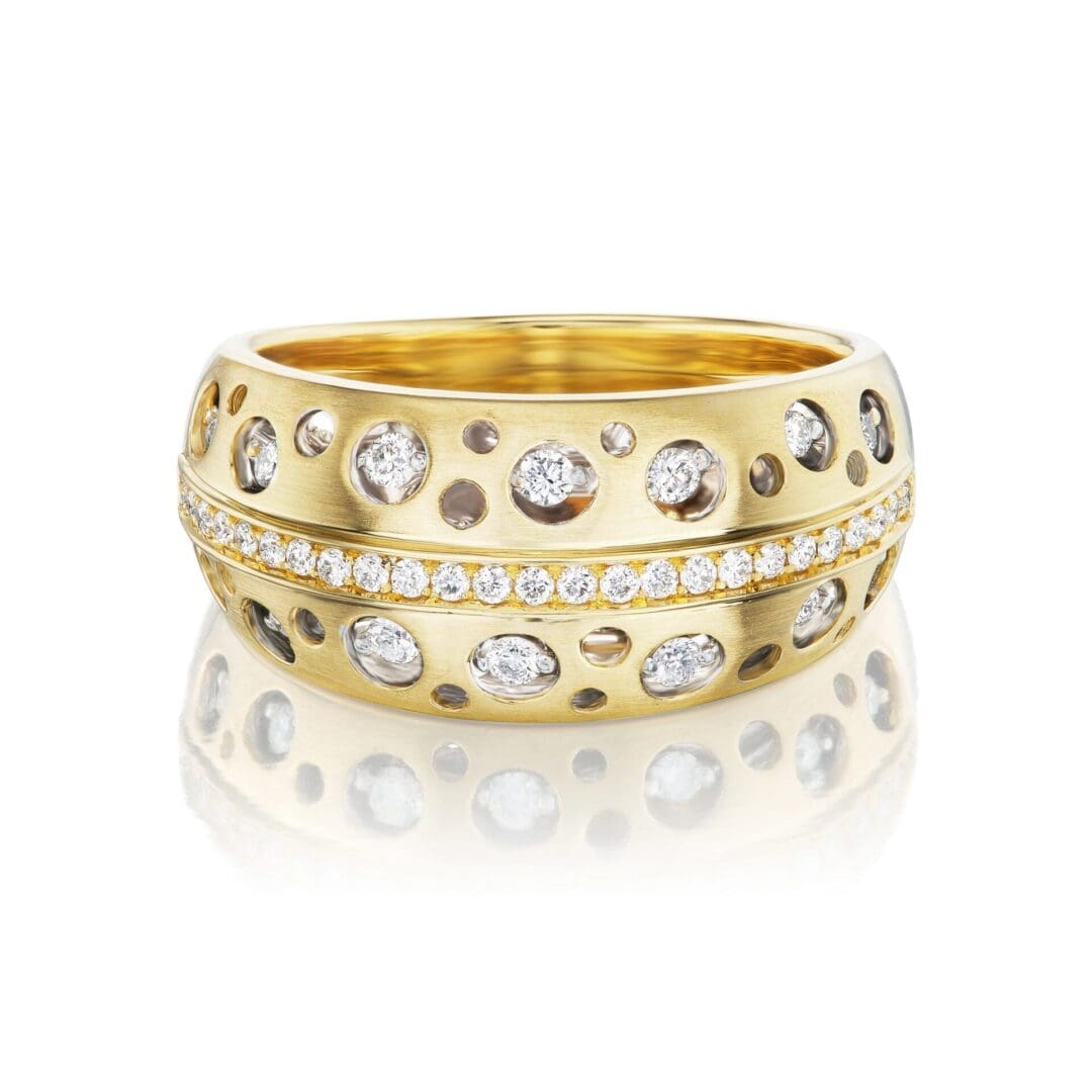 A gold ring with diamonds on top of it.