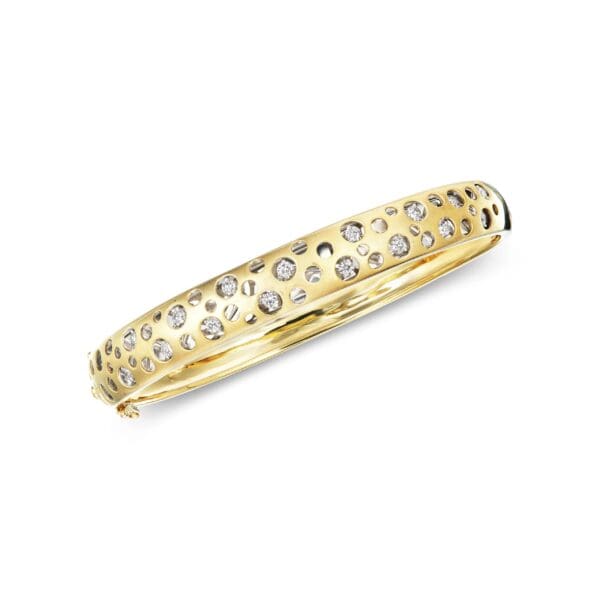 A yellow gold bangle with diamonds.