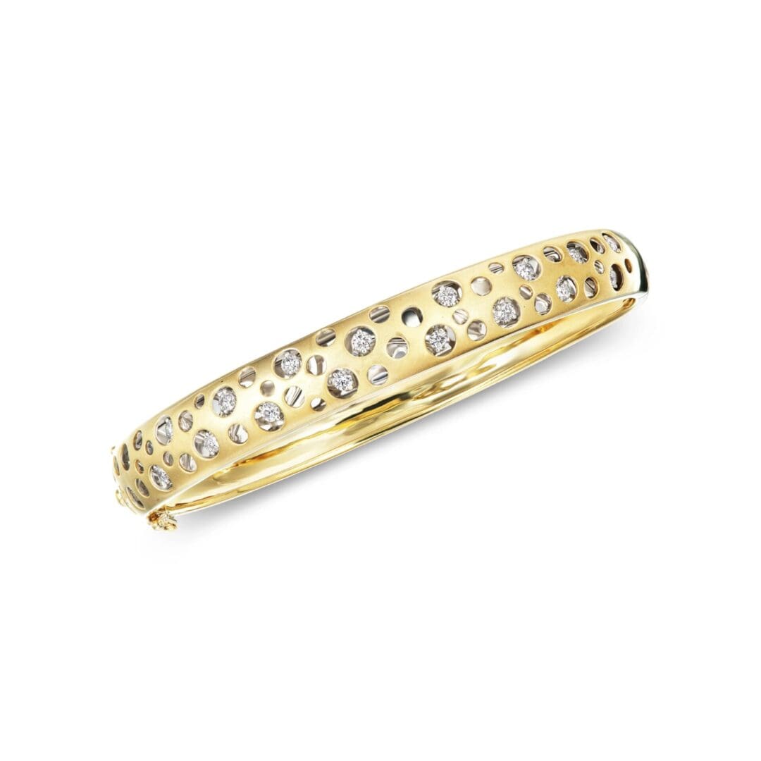A yellow gold bangle with diamonds.