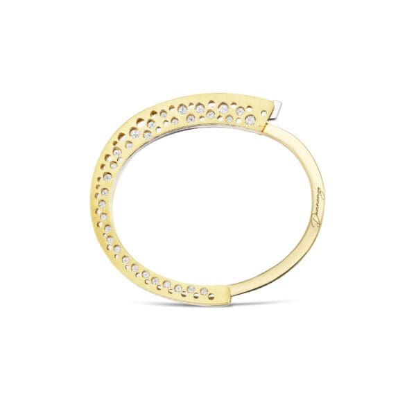 A gold ring with some white diamonds on it