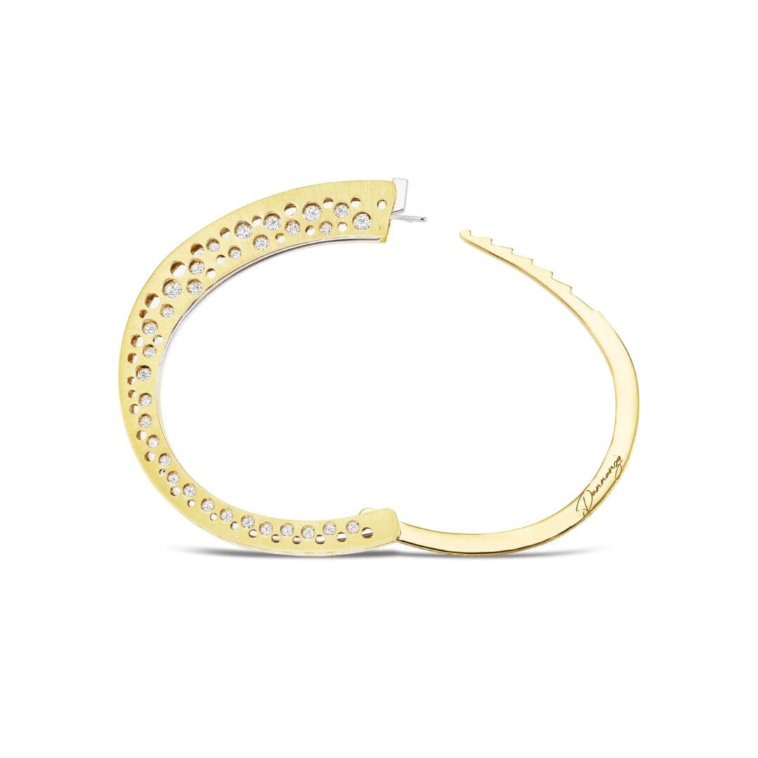 A pair of gold earrings with diamonds on them.