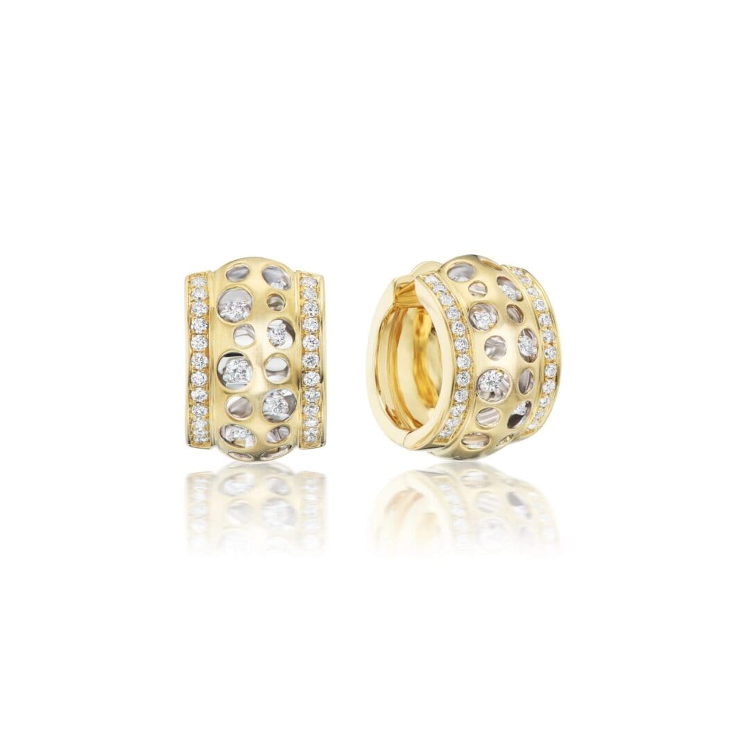 A pair of gold earrings with diamonds on them.