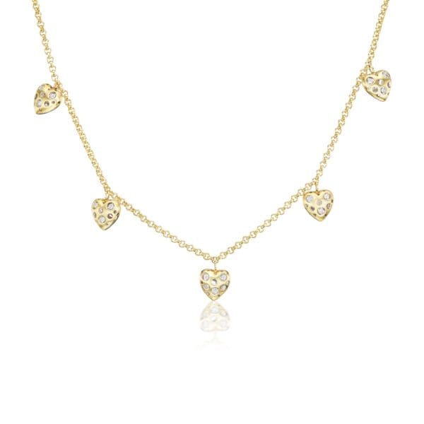 A gold necklace with five hearts hanging from it.