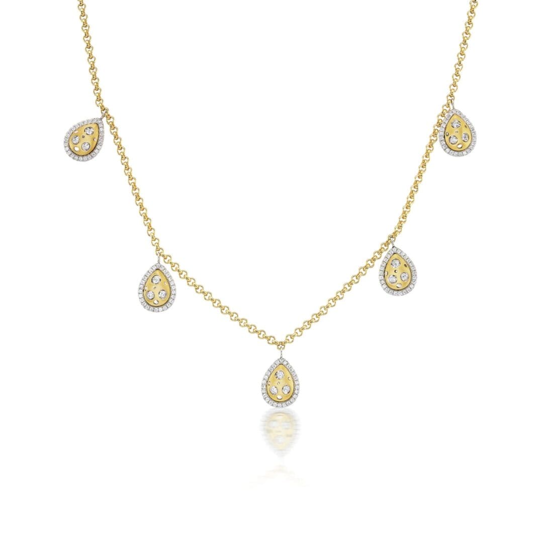 A gold necklace with five dangling charms.