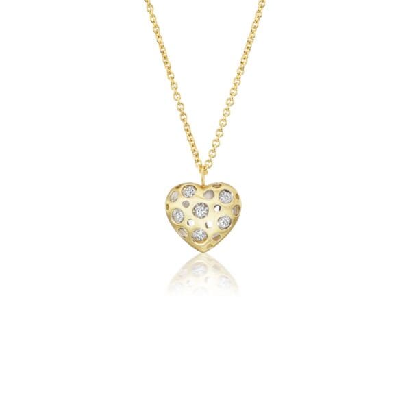 A gold necklace with a heart shaped pendant.