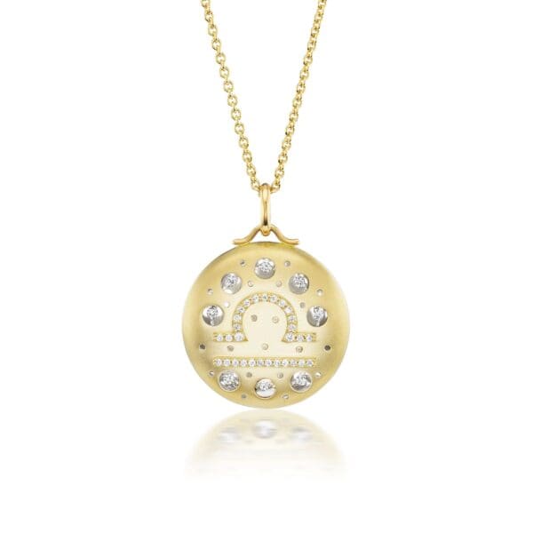 A gold necklace with a picture of a horse.