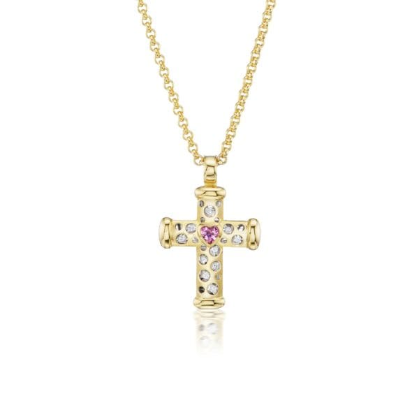 A gold cross with pink and white stones.
