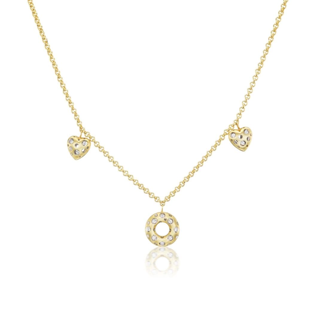 A gold necklace with three hearts and one diamond.