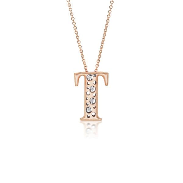 A rose gold initial necklace with diamonds.