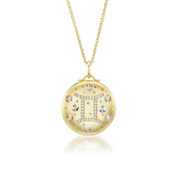 A gold necklace with a letter on it