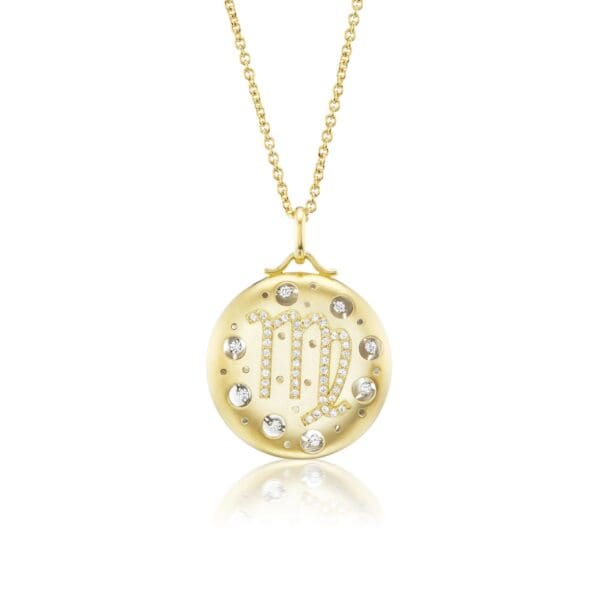 A gold necklace with a large pendant on it