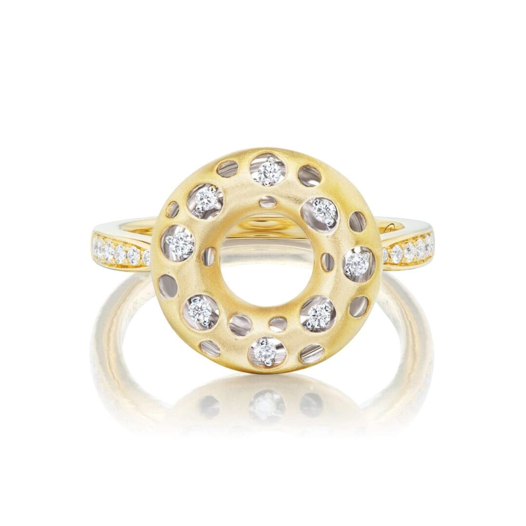 A yellow gold ring with diamonds on top of it.