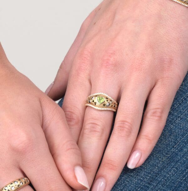 A woman 's hands with two different rings on her fingers.