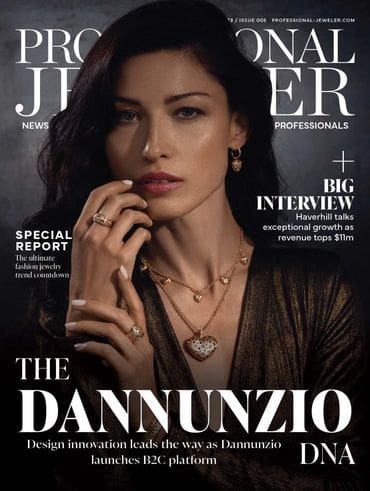 A woman wearing jewelry and a black jacket.